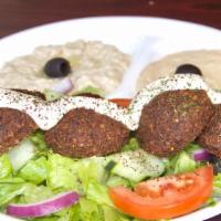 Veggie Falafel Plate · Fried Falafels  over Greek salad and topped with tahini sauce. Served with hummus, babaganou...