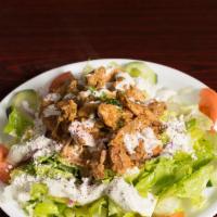 Chicken Shawarma Salad · Marinated grilled chicken served on a Greek salad and topped with tahini and garlic sauce.
