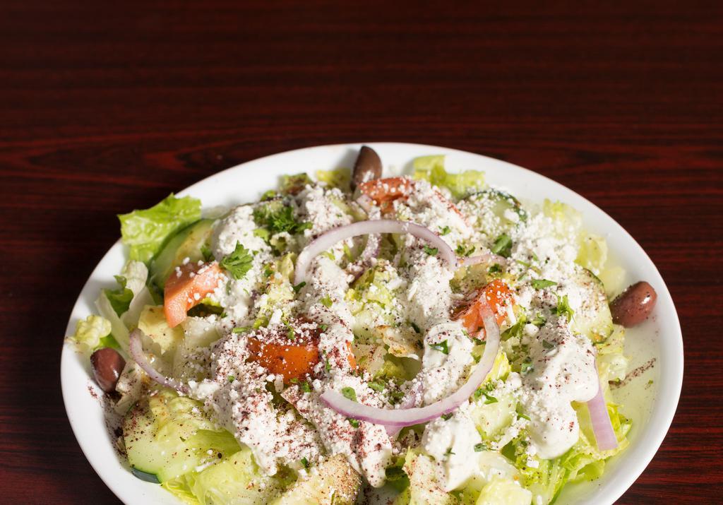 Greek Salad · Romaine lettuce, tomatoes, cucumber, Feta cheese, red onion, olives, pepperoncini with Italian dressing and tzatziki.