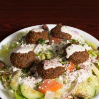 Falafel Salad · Falafel served over a Greek salad. Topped with tahini sauce.(No dairy)