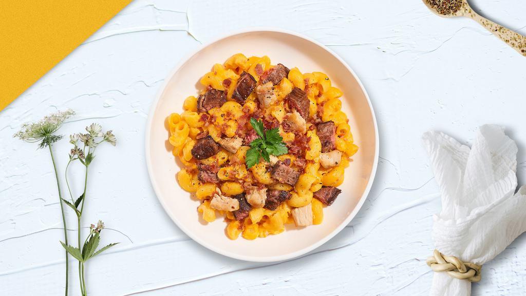 Meat Monster Mac · Traditional mac and cheese cooked with chicken, bacon, and steak to give a rich flavorful meal.