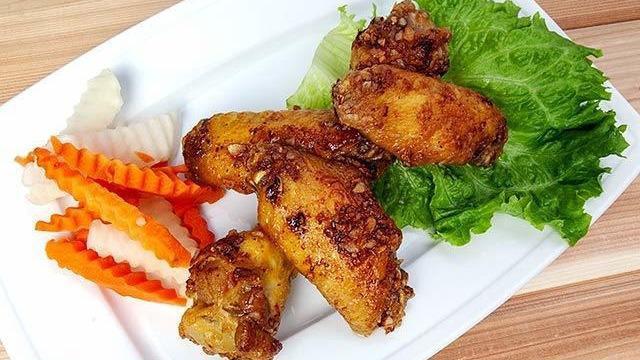 A 6 - Chicken Wings · Deep fried wings with garlic tossed caramelized fish sauce