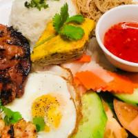 Cơm Ðặc Biệt - Combination · Combo rice dish with charbroiled pork chop, shrimp skewer, pork skin, fried egg and egg cust...