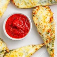 Garlic Bread - Half · House-made flat bread with garlic butter spread. served with marinara cup