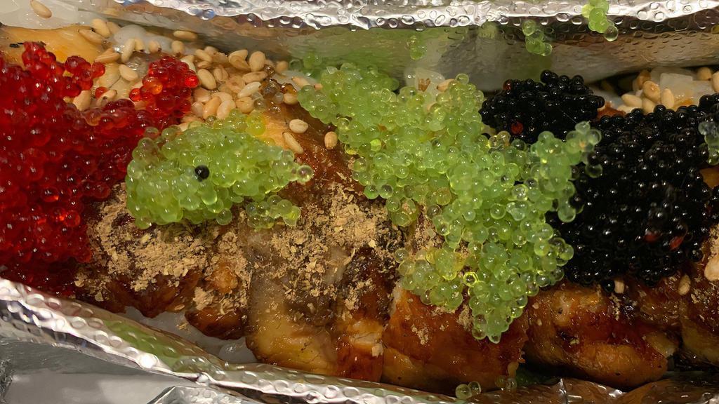Dragon Roll · shrimp tempura, crab meat, and avocado w/ eel, tobiko on top