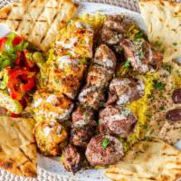Mixed Grill · Beef, lamb, chicken and kofta kabab with humus, salad, tehini sauce, and pita bread.