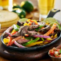 Steak Fajitas · Delicious marinated steak sautéed with bell peppers and onions, served on a sizzling platter...