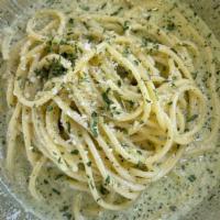 Creamy Pesto · Basil pesto, onions, parmesan cheese and spaghetti noodles.