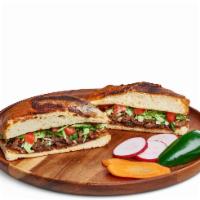 Torta · Mexican bread filled with meat, lettuce, tomato, onions, cilantro, and mayonnaise.