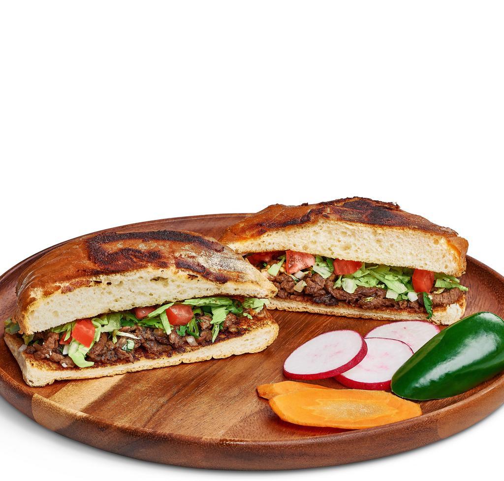 Torta · Mexican bread filled with meat, lettuce, tomato, onions, cilantro, and mayonnaise.