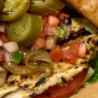 Loco Pollo Sandwich · Brined and grilled to order tender chicken breast served over Romaine lettuce with a slice o...