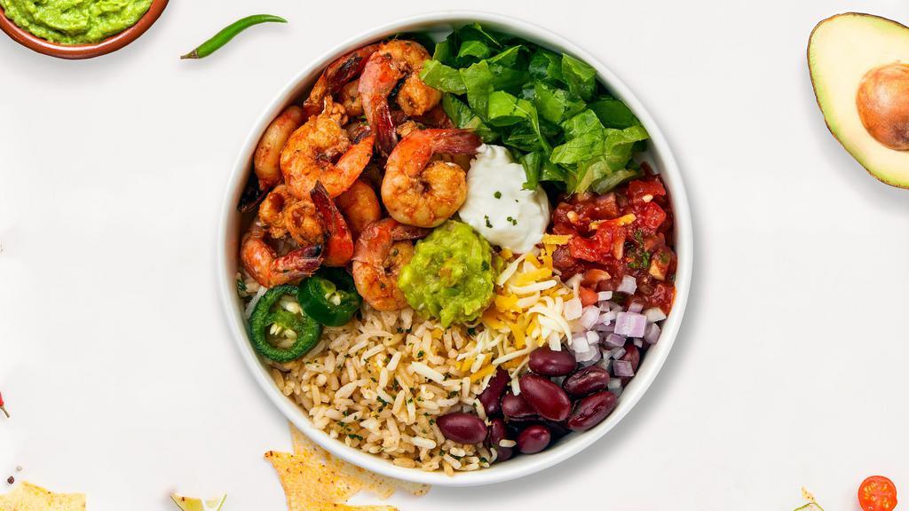 Keep It Shrimple Bowl · Fresh grilled shrimp topped with Romaine lettuce, black beans, cilantro lime rice, sautéed onions, pico de gallo, avocado puree, and crema served in a bowl and with cilantro lime vinaigrette.