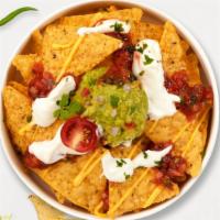 All Out For Chips · Toasty tortilla chips with a scoop of salsa and guacamole.