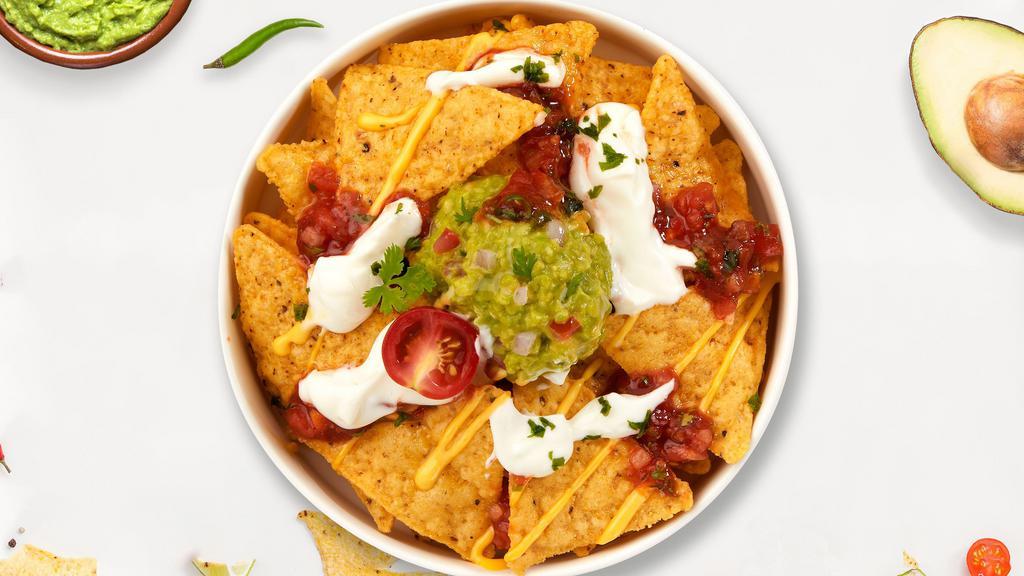 All Out For Chips · Toasty tortilla chips with a scoop of salsa and guacamole.