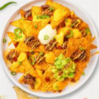 Chunky Grill Nachos · Tortilla chips, chicken, black beans, cheese sauce, Mexican cheese blend, avocado purée, pic...