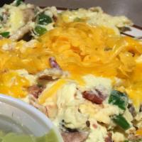 Wrecked Eggs · Three eggs scrambled with bacon , green onions, mushrooms & cheddar cheese, aside sour cream...