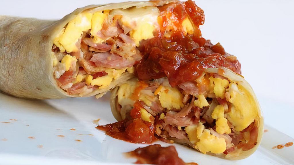 Mom'S Burrito · Mexican blend cheese, scrambled eggs, pork sausage, bacon, and ham all wrapped in a flour tortilla with a side of hot sauce.