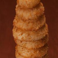 Towering Onion Rings · A golden monument to goodness, thirteen rings tall. Served with campfire sauce and ranch dre...
