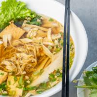 Golden Noodle Soup · Fresh yellow noodle, soy chicken ham, fried tofu, five spices bean curd, vegan shrimp, mince...