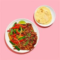 Steak Fajitas · Steak fajitas with pepper and onions, shredded cheese, salsa, and rice. Served with flour to...