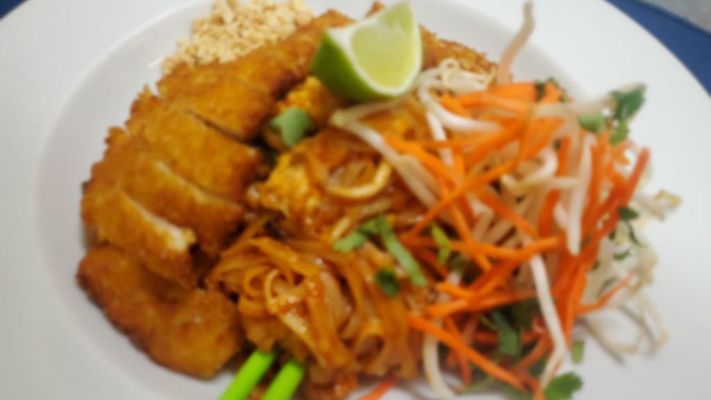 Padthai With Crispy Chicken. · Rice noodles stir-fried with egg, chive and bean sprout with traditional tamarind sauce topped with crispy chicken, peanut, carrot and lime.