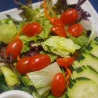Mixed Green House Salad  · Mixed green salad including cucumber and tomato served with special house sesame dressing.