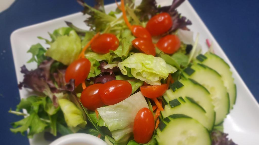 Mixed Green House Salad  · Mixed green salad including cucumber and tomato served with special house sesame dressing.