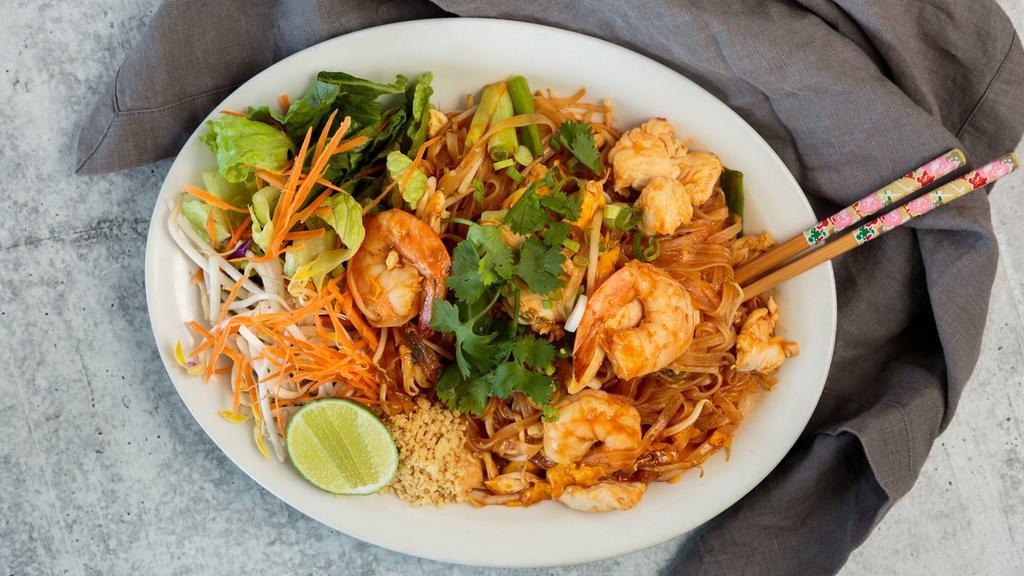 Pad Thai · Rice noodles stir fried with egg, chives and bean sprout with traditional tamarind sauce topped with peanut, carrot and lime. Add chicken, beef, shrimp for an additional charge.