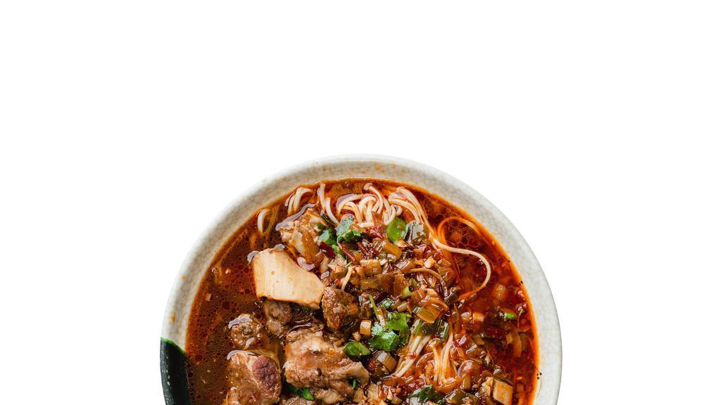 Spicy Beef Noodle Soup · Braised beef stew simmered in ma la spicy broth with fresh handmade egg noodles topped with bok choy, scallions, and cilantro.