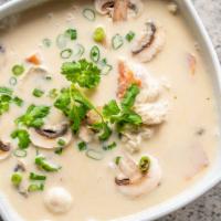 Tom Kha Chicken  · Coconut milk soup with chicken, onions, tomatoes, mushrooms and baby corn.
