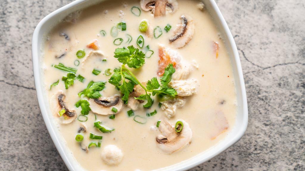 Tom Kha Chicken  · Coconut milk soup with chicken, onions, tomatoes, mushrooms and baby corn.