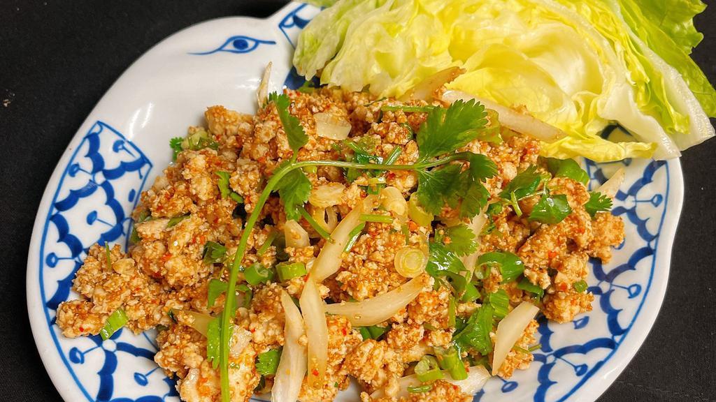 Laab (Minced Chicken Salad) · Ground chicken mixed in a lime juice sauce with toasted rice powder, green onions and mint.
