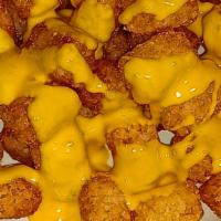 Cheesy Tater Tots Basket · Large portion of deep fried tater tots drizzled with nacho cheese