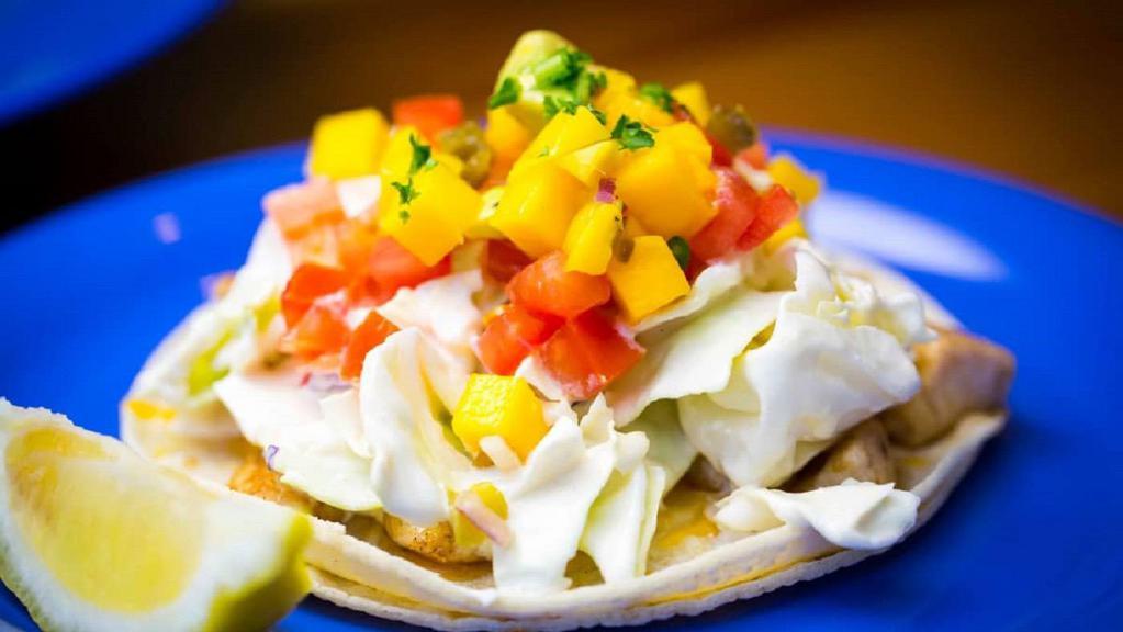 Fish Tacos · Gluten free. Two tacos per order made with 17 ingredients, including grilled ono and mahi mahi, white corn tortilla, organic tomato salsa, cheese, house made coleslaw and mango salsa.
