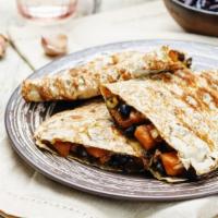 Refried Bean Quesadilla · Grilled tortilla filled with refried beans, melted cheese and lettuce. Served with guacamole...