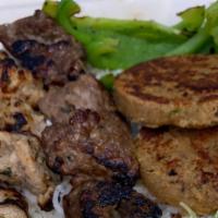 Assorted Kebab Plate · Assortment of Lamb, chicken and Shami kebabs on a bed of rice with side of naan, lettuce, pi...