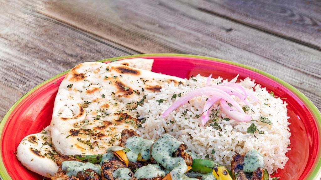 Lamb Kebab Plate · Skewered lamb with rice, naan, lettuce and pickled onions