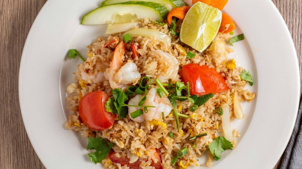 Thai Fried Rice · Jasmine rice wok with egg, tomatoes, onions, scallions and cilantro.
