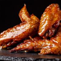 The Honey Hot Wings · Crispy chicken wings tossed in honey hot sauce flavor, served with side of ranch or bleu che...