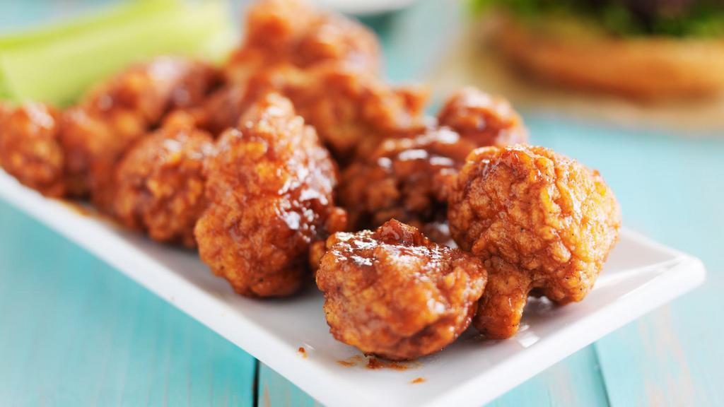 Honey Bbq Boneless Wings · Boneless! Crispy chicken wings tossed in honey BBQ sauce for flavor, served with side of ranch or bleu cheese.