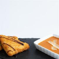 Arancini · Crusted parmesan risotto, braised tomato basil sauce,
balsamic glaze