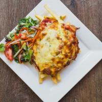 Chicken Parmigiana · Breaded chicken breast, on a bed of pasta with cheese, and marinara sauce.