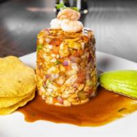 Tostada De Ceviche · Shrimp cooked with lime juice, red onion, cucumber, avocado, Maggi house sauce.