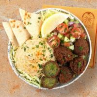 Falafel Hummus Bowl · Crispy falafel over hummus, diced cucumber and tomato salad, shredded green cabbage and a dr...