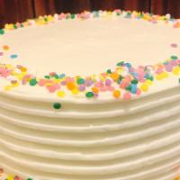 Confetti Birthday - Slice · Light sponge cake dotted with colored sprinkles, vanilla syrup, vanilla butter cream frostin...