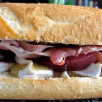 Brie & Prosciutto Sandwich · Butter spread, brie and prosciutto on our house made baguette