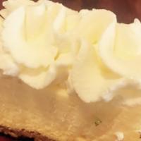 Cheesecake Bite · Vanilla cheesecake and graham cracker crust topped with whipped cream.