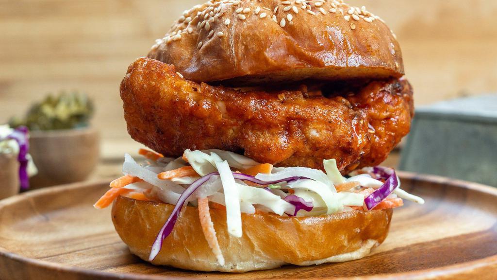 Kfc Sandwich · Korean fried chicken breast tossed in a sweet and spicy Korean Chile sauce served with pickled daikon and pickled carrot tossed together with slaw.
