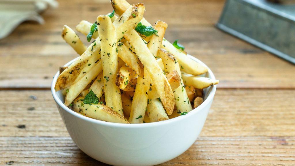 Garlic Herb Fries · Crispy natural cut fries tossed in fresh herbs and garlic oil. Served with side of garlic aioli.