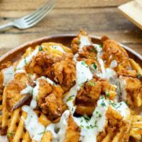 Chicken ＆ Waffle Fries · Waffle fries topped with pieces of crispy chicken and country gravy. (Gravy is served on the...